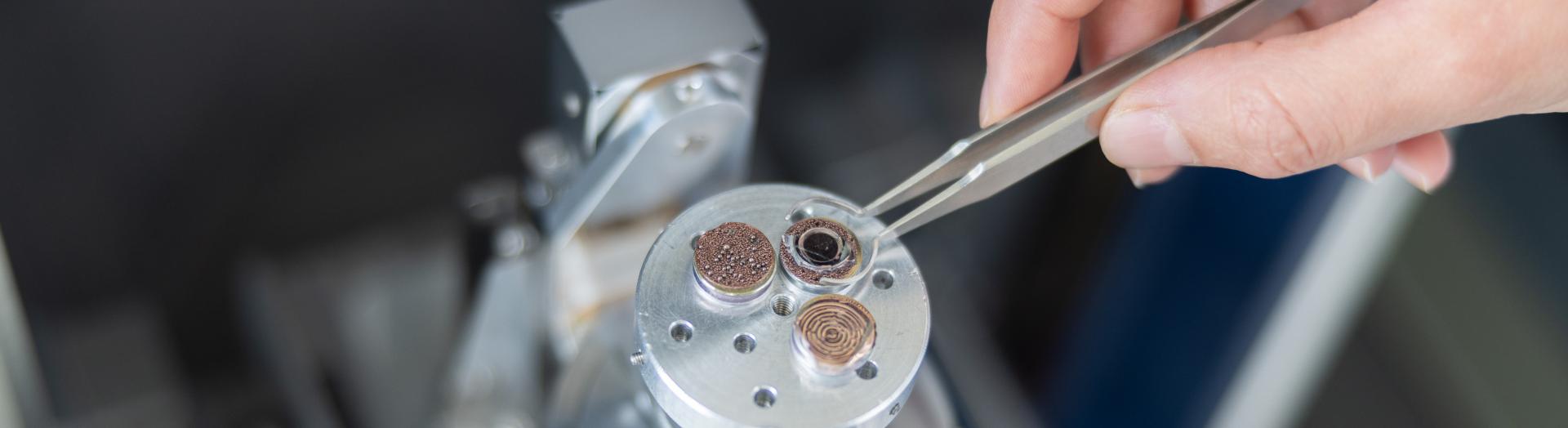 Hand eines Forschers arbeitet an Forschungsobjekt