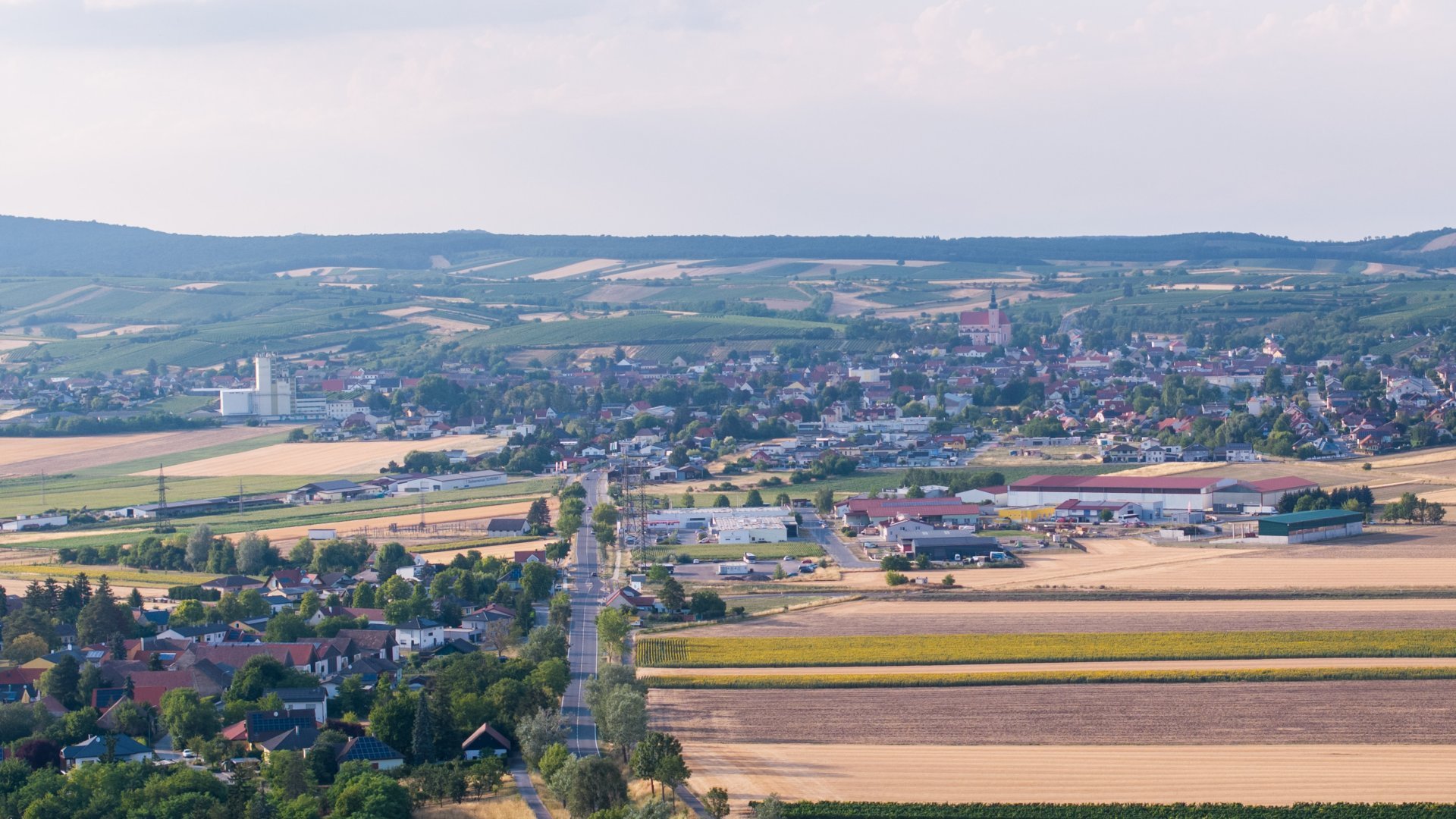 Drohenansicht von dem Wirtschaftspark Poysdorf vor der Stadt Poysdorf im Hintergrund