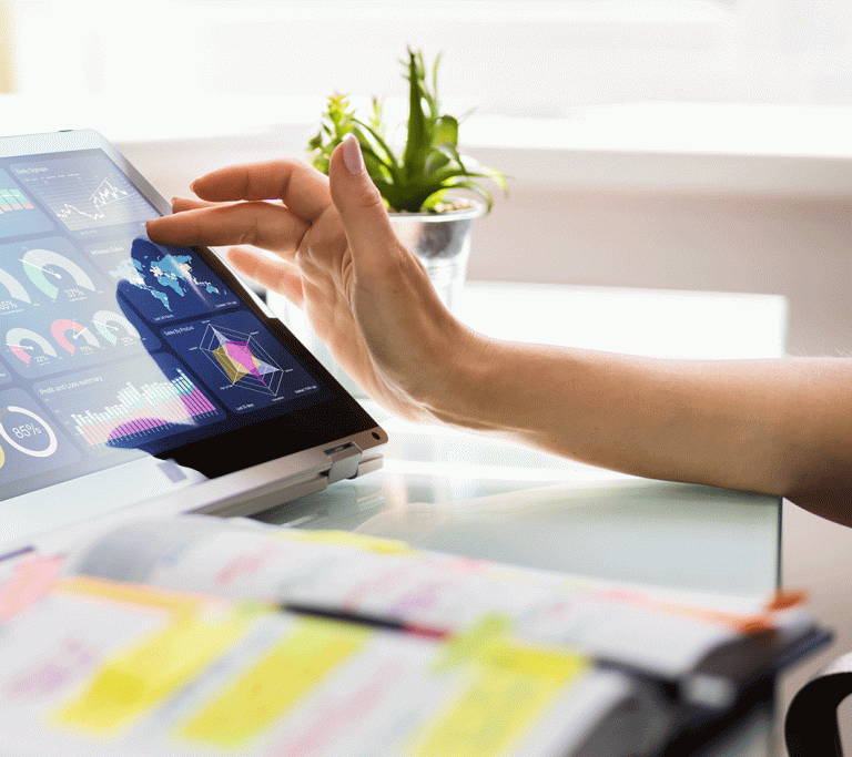 Eine Frauenhand scrollt durch die Datenanalyse eines Unternehmens
