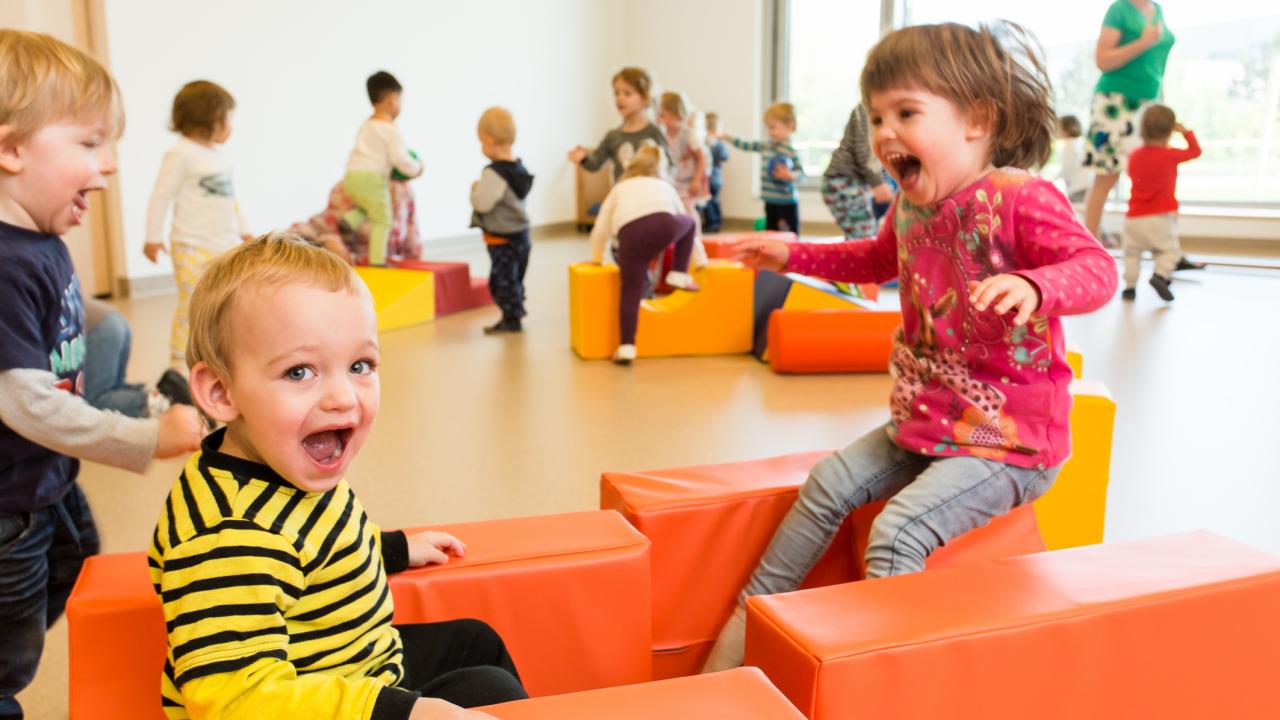 IZIBIZI kids corner Bewegungsraum - tobende Kinder inmitten bunter Spielklötze