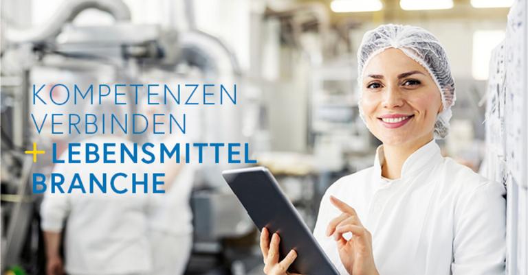 eine Person lächelt in die Kamera und hält ein Tablet