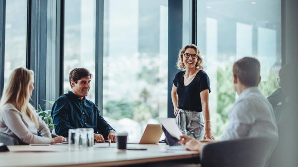 Business Meeting mit fünf Personen in hellen Büroraum