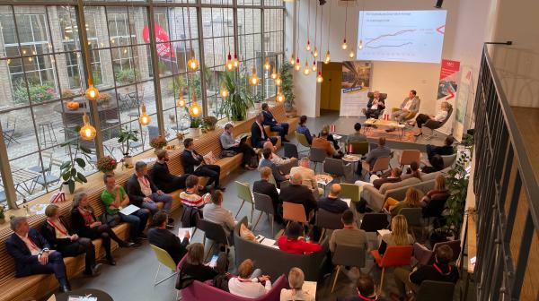 Room with people photographed from above during a presentation with a screen