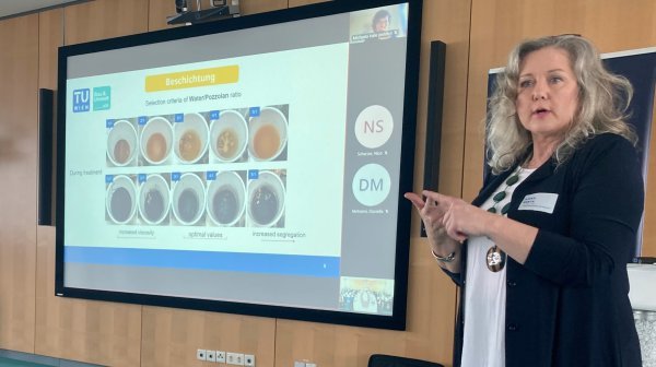 Frau neben Präsentationsbildschirm