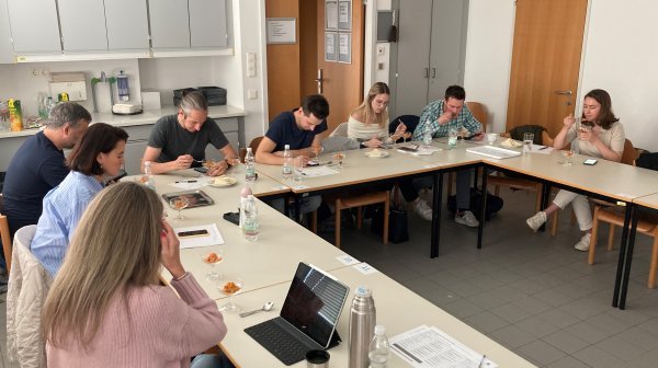 Personen sitzen an Tischen während des Workshops